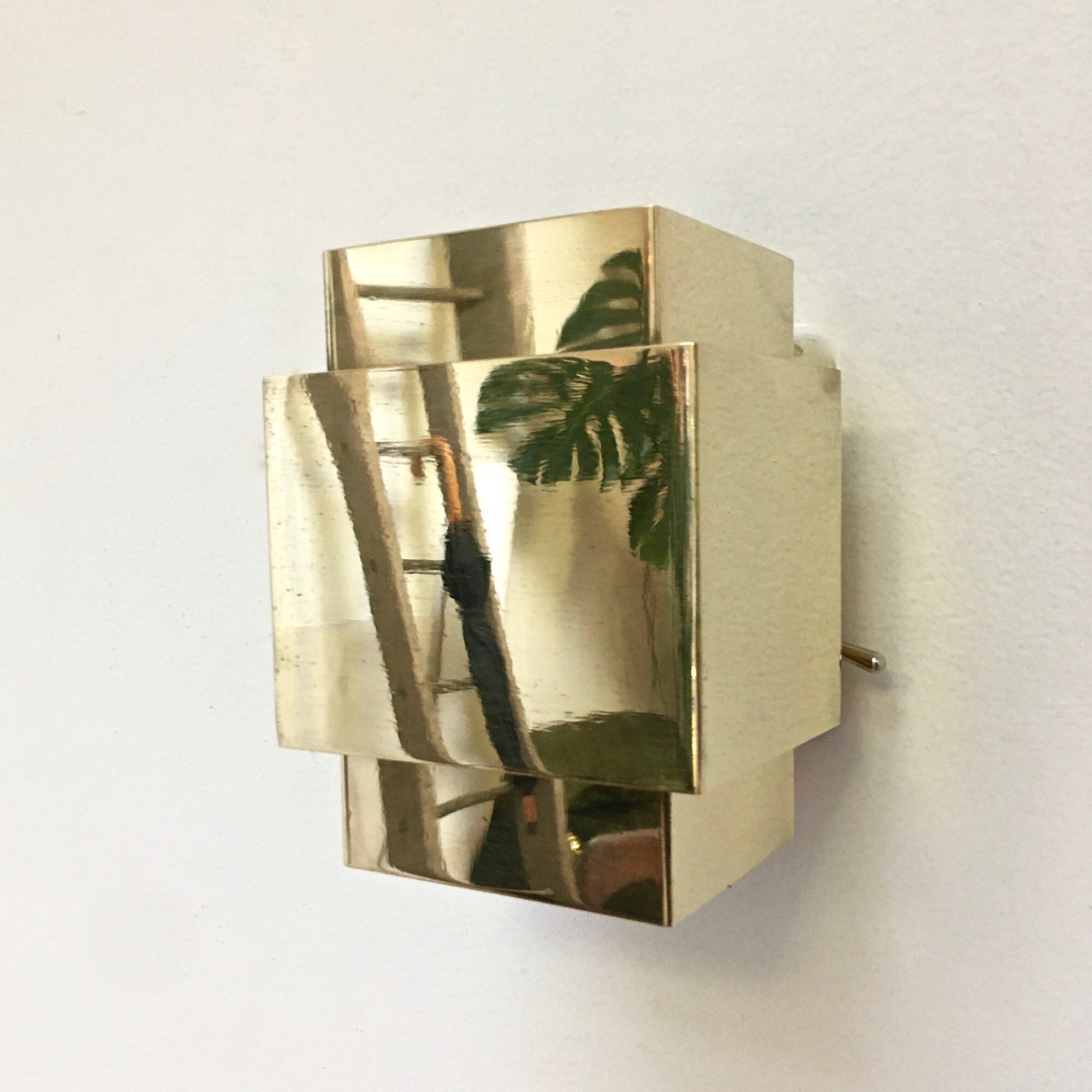 Cubical brass wall light