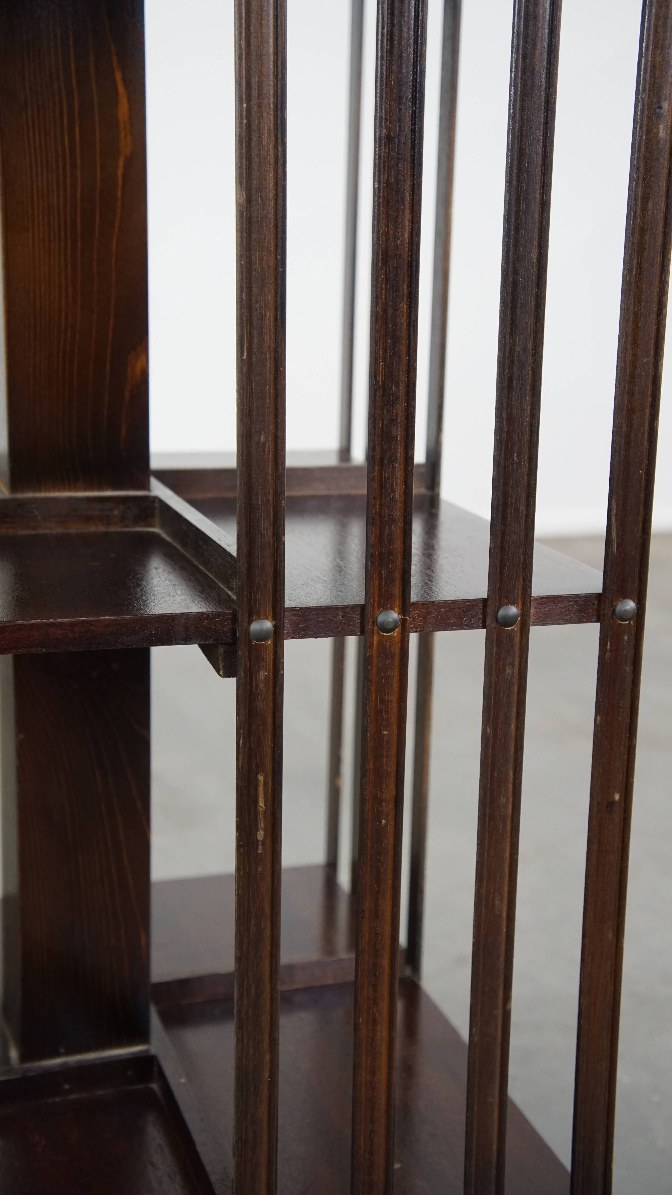 Wooden bookstand with green leather surface and on wheels in English style