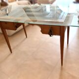 Elegant antique desk in cherry wood with a black leather top and glass plate.