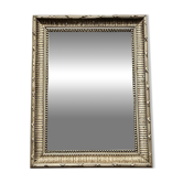 Mirror in a frame with a moulding.