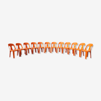 12 stackable orange plastic chairs