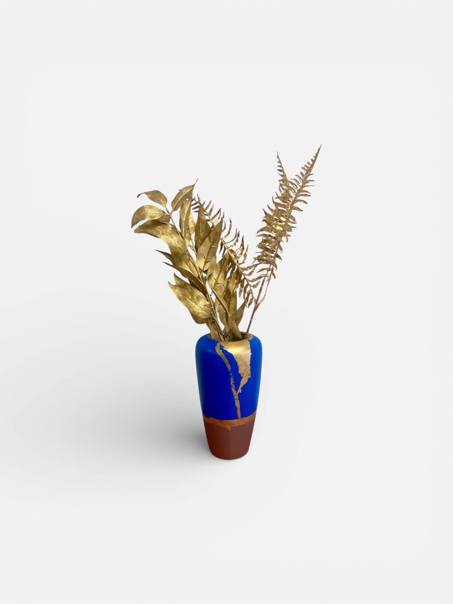 Electric blue and frosted brown decorative vase with gold leaf.