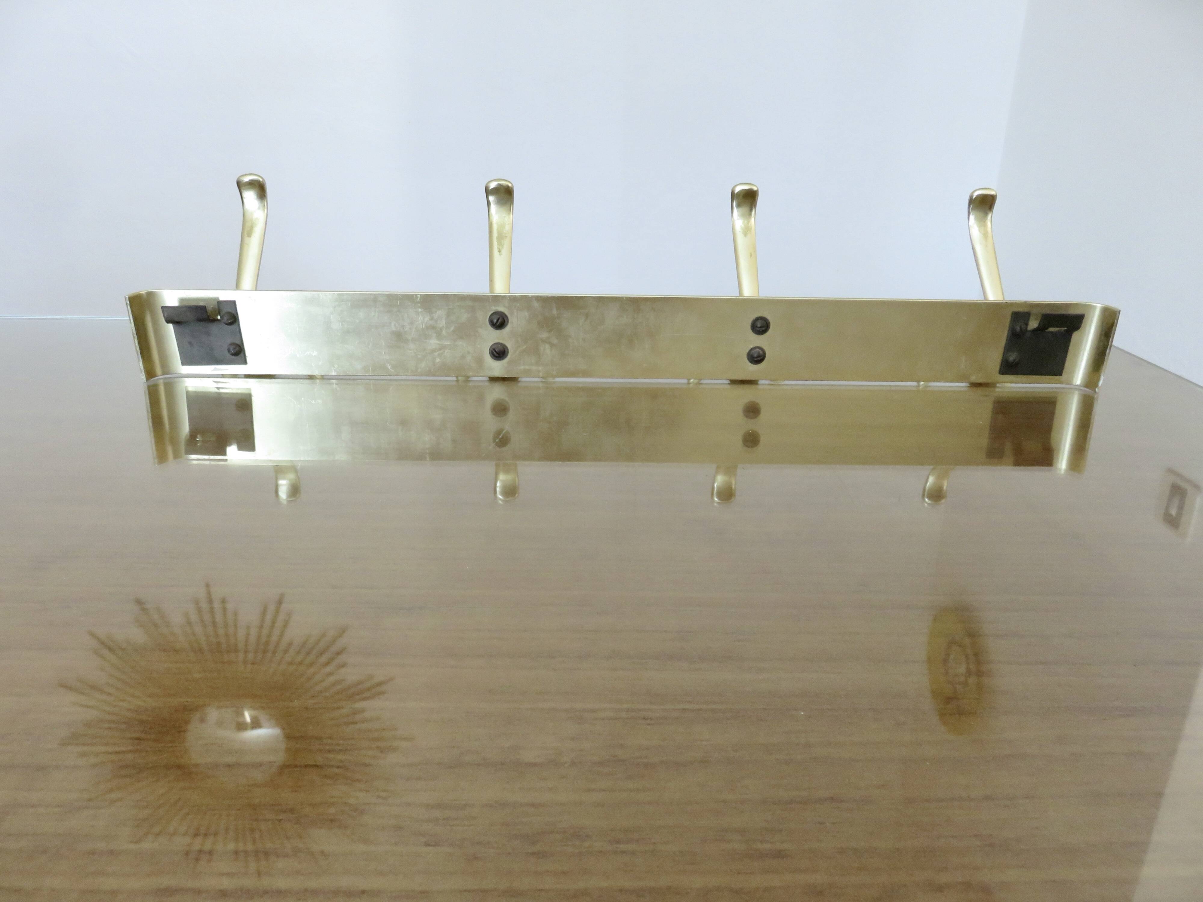 Large wall-mounted coat rack in gold aluminum, 60s-70s