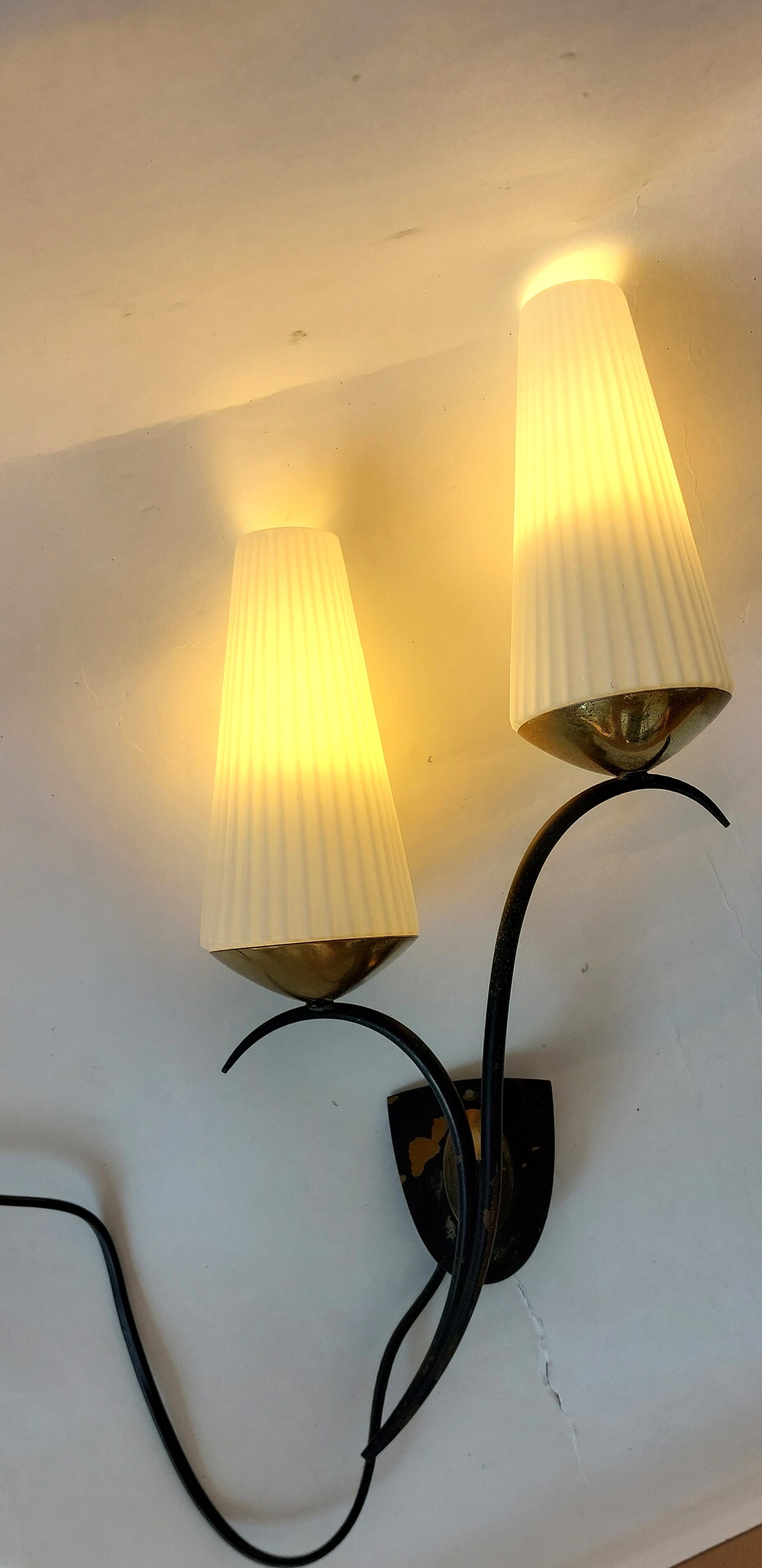 Wall lamp in black metal and gilded brass 1960 with two lights.