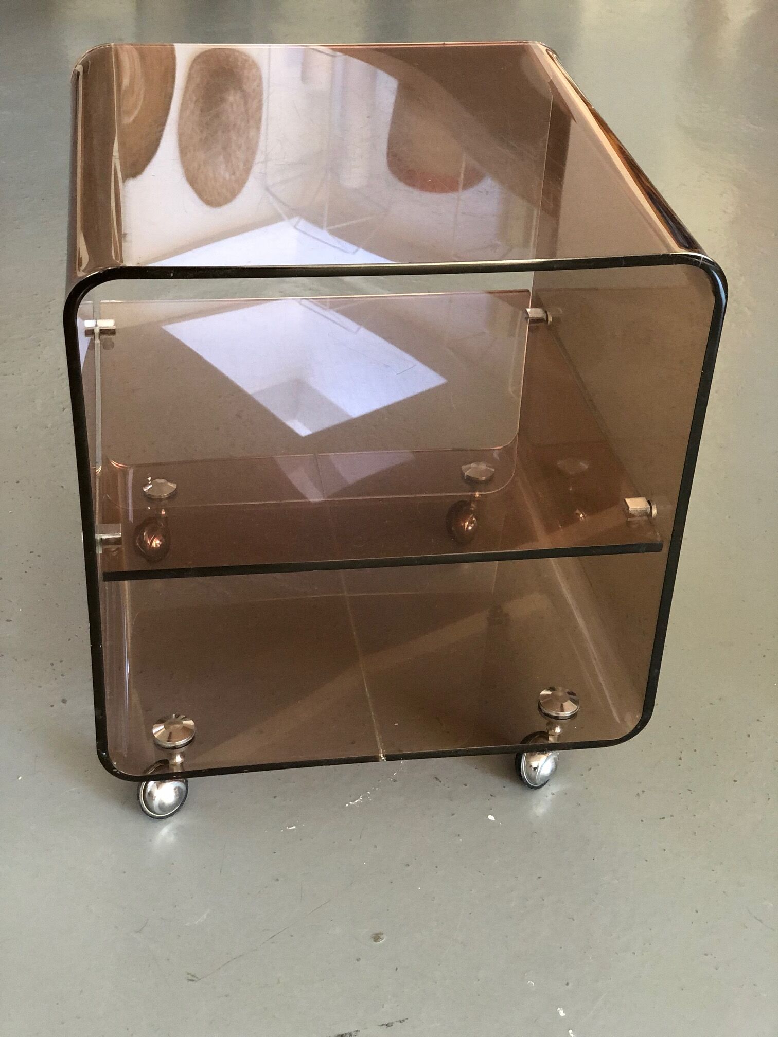 Served on wheels in smoked brown plexiglass 70s.