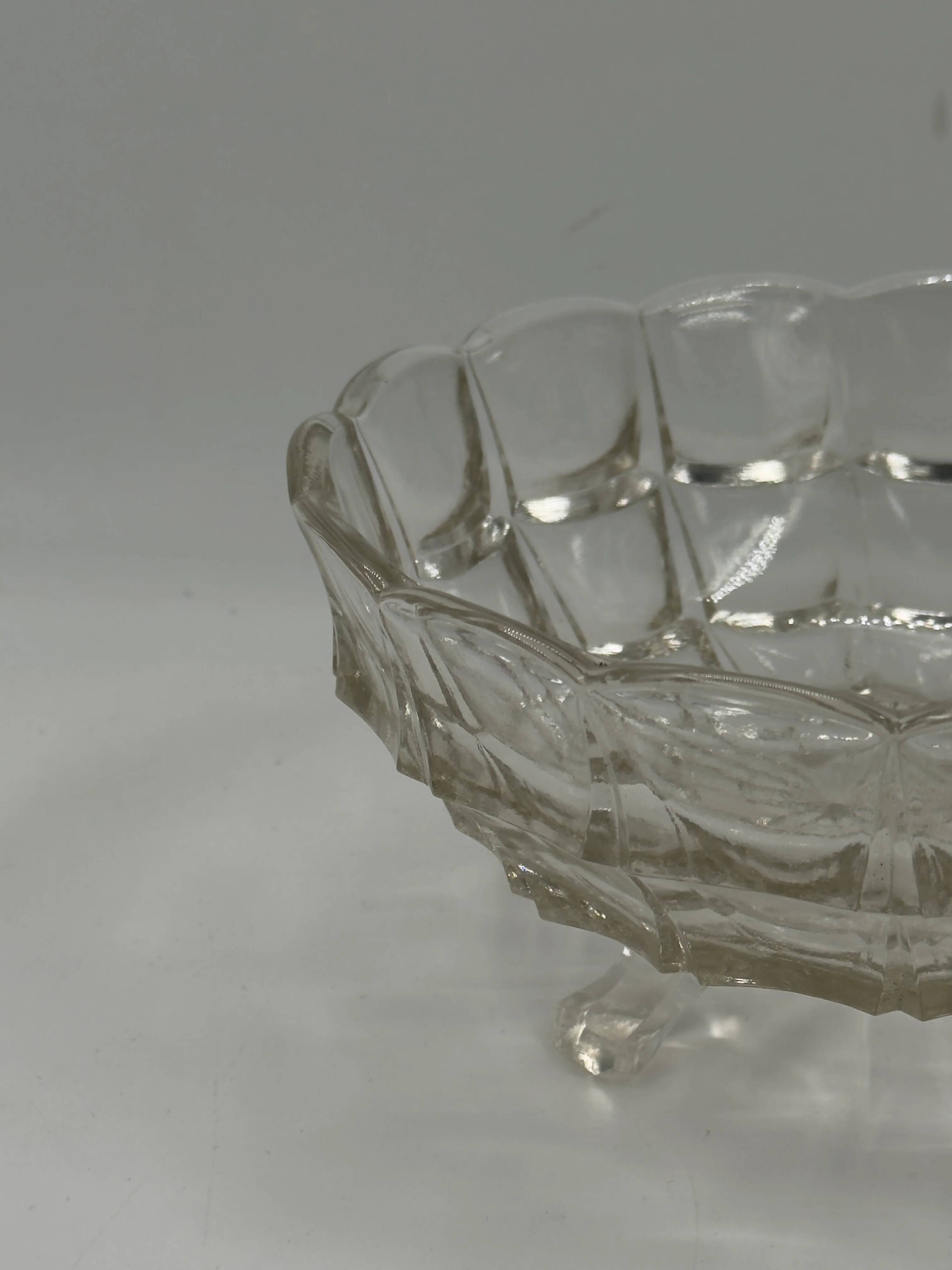 Vintage pressed glass footed coupe with scalloped diamond-cut edge.