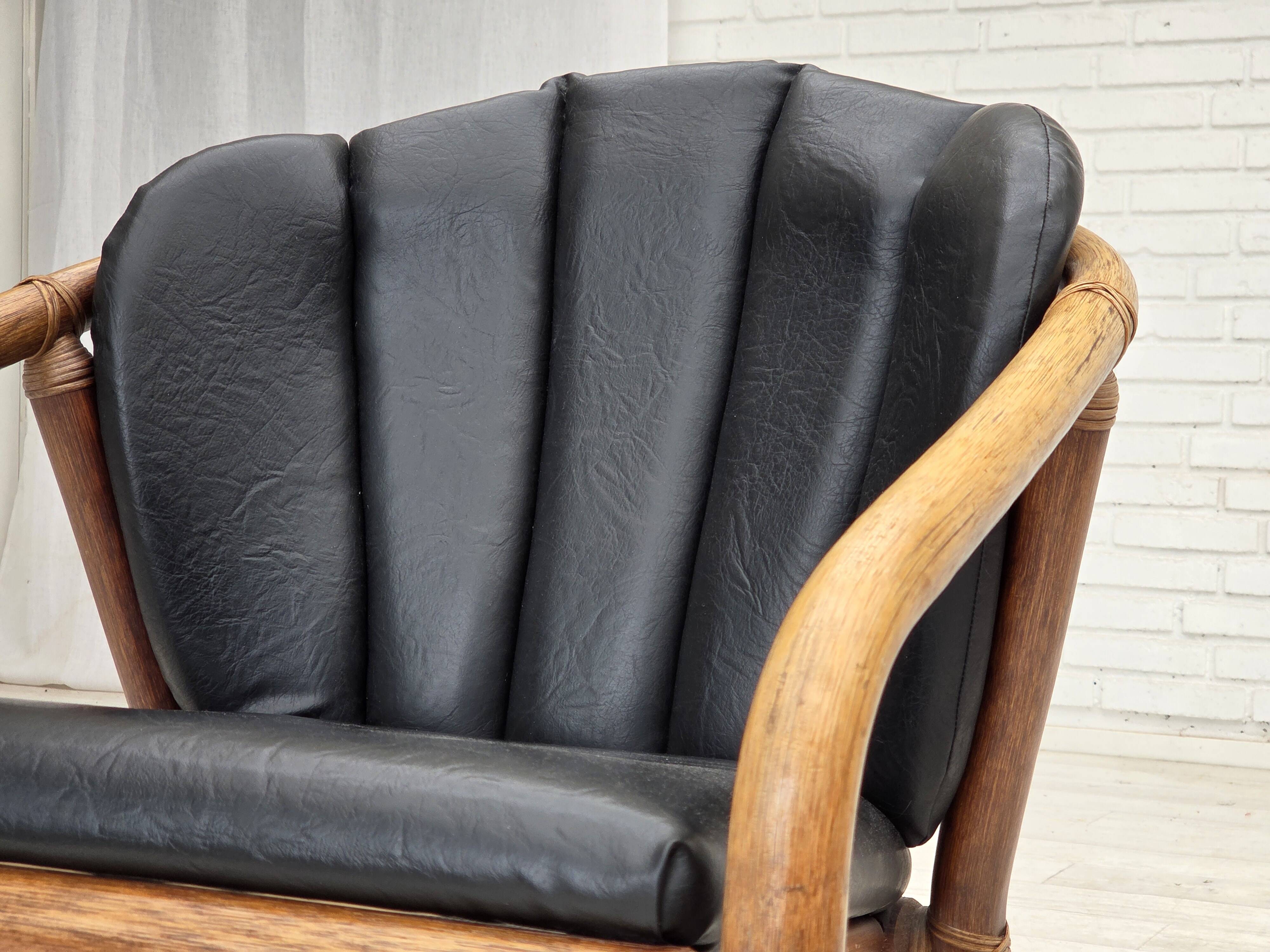 1970s, Danish armchair, rattan, black artificial leather.