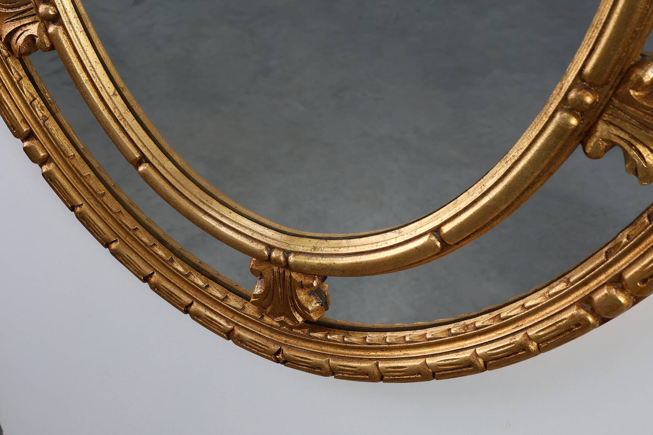 20th century neo-classical style tilted oval mirror by Deknudt, Belgium