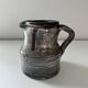 Patinated pitcher signed