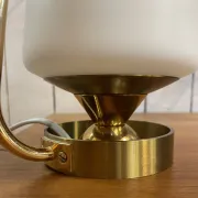 Table lamp in gold metal and opaline.