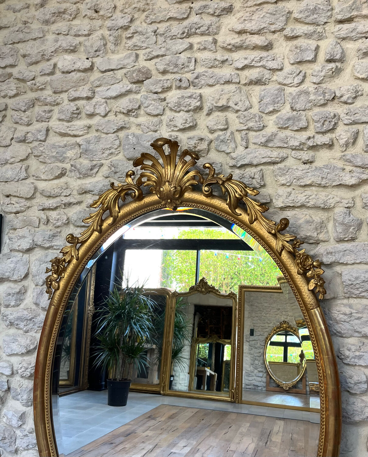 Oval mirror with pediment, beaded gilded with gold leaf