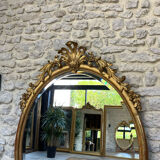 Oval mirror with pediment, beaded gilded with gold leaf