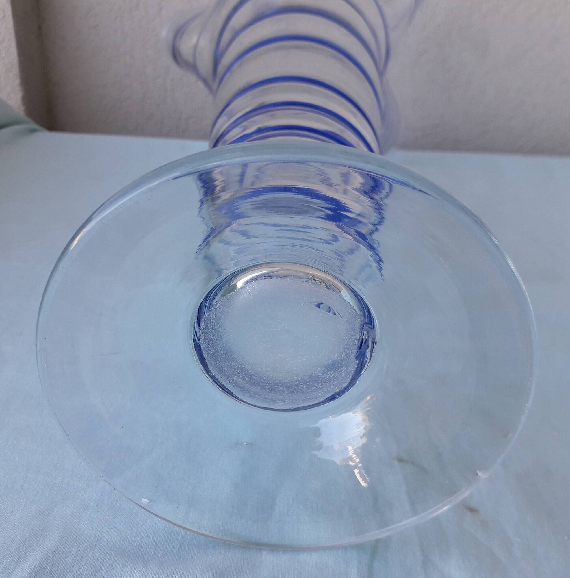 Glass vase on a pedestal with a blue trim.