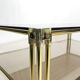 Brass two-tiered coffee table hollywood regency gold smoked glass 1970s