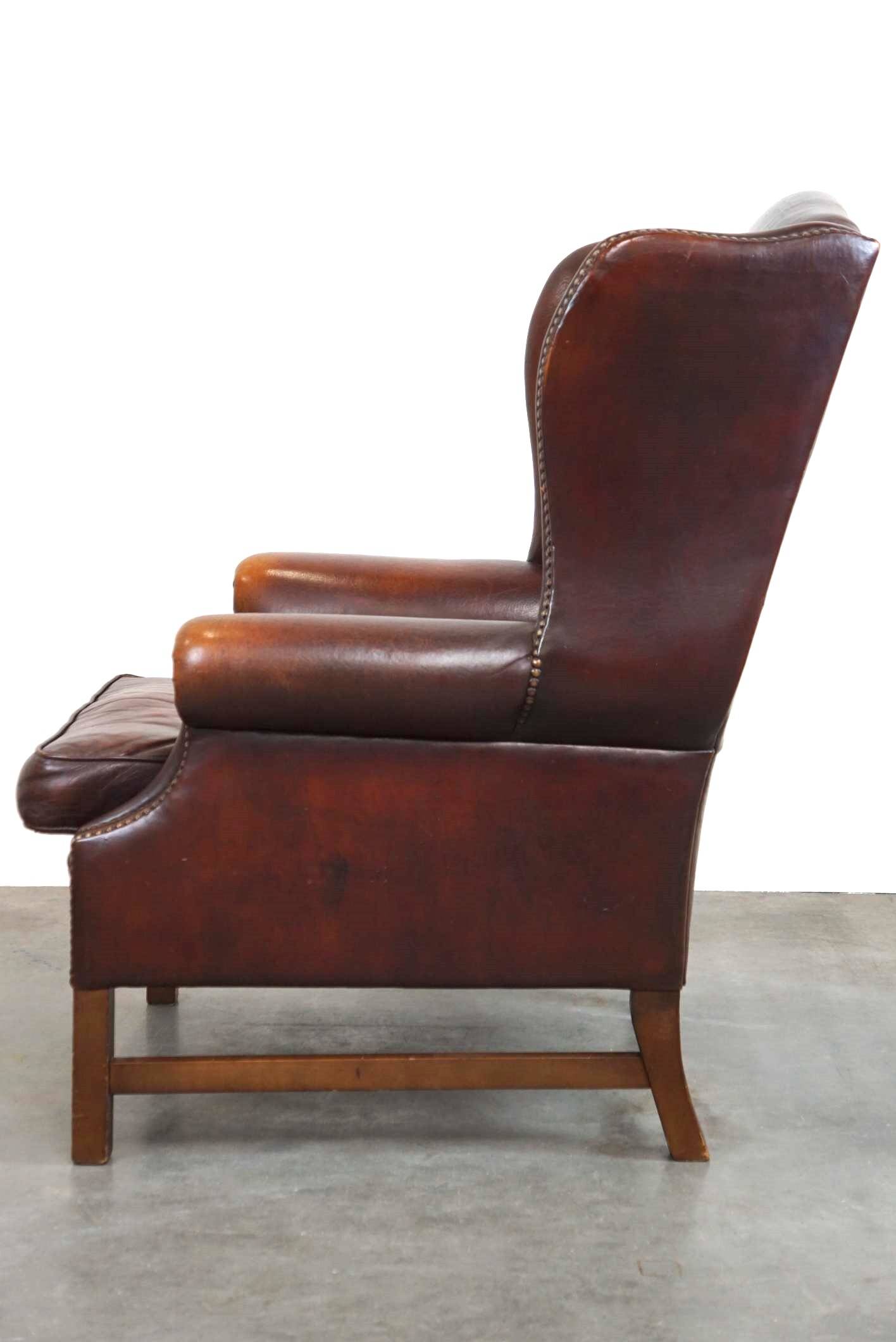 Beautiful classic and stately wingback armchair made of sheep leather with beautiful colors