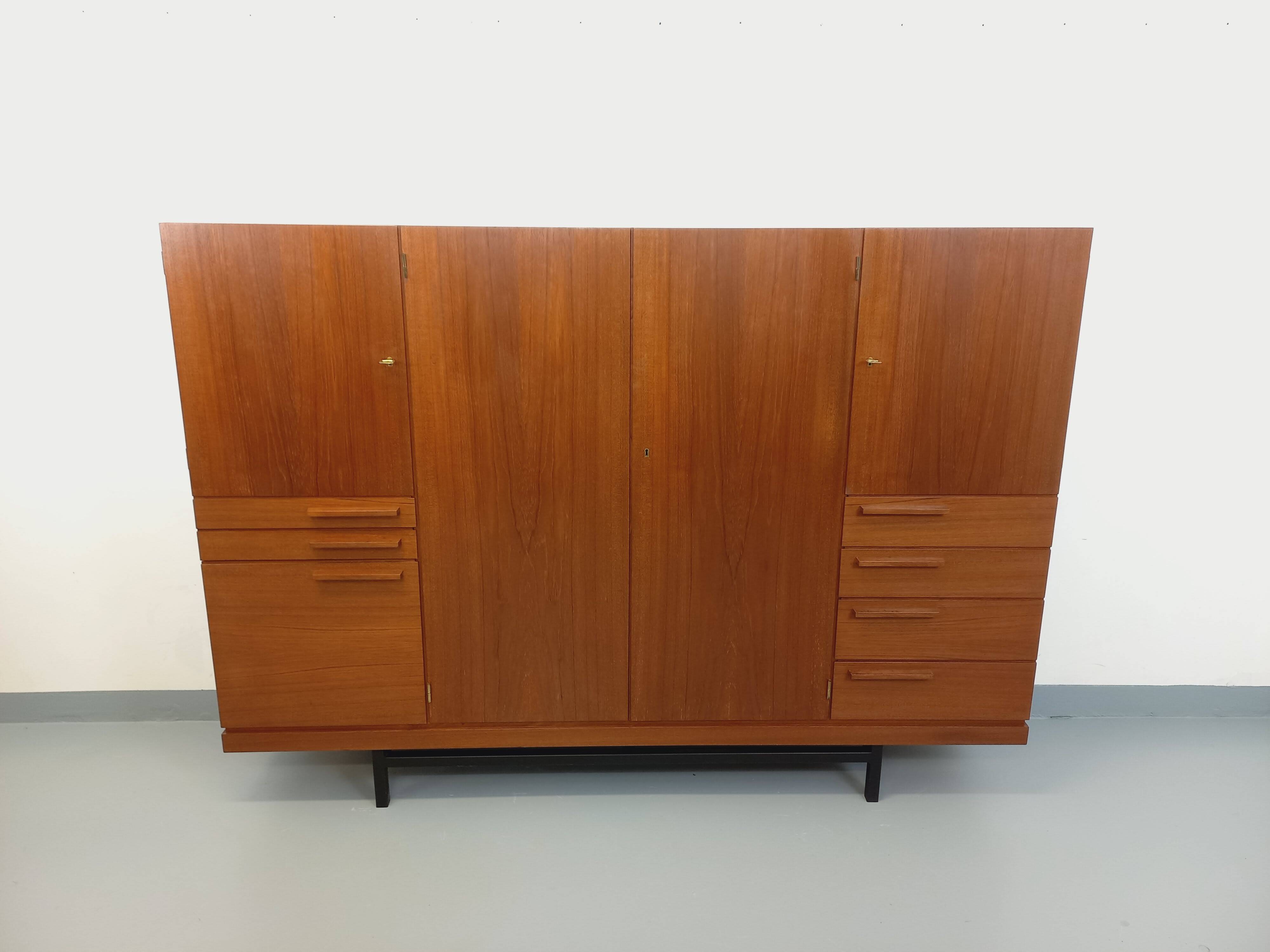 High Scandinavian modernist vintage sideboard in teak and black metal.