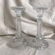 Column candle holders in moulded glass made in France.