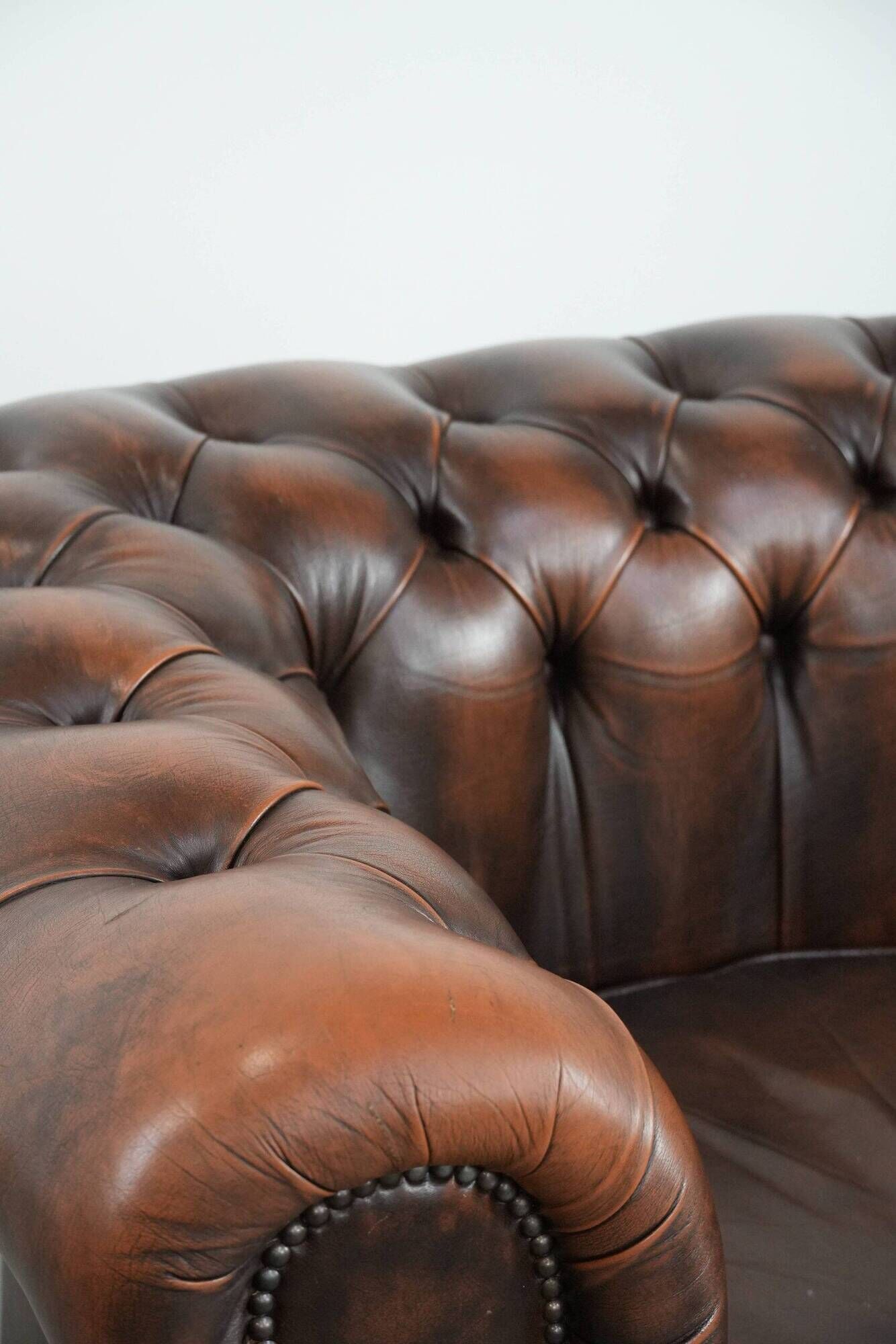 Brown Chesterfield armchair made of cowhide leather in English style