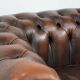 Brown Chesterfield armchair made of cowhide leather in English style