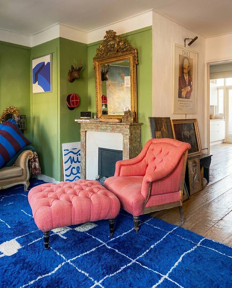 Napoleon III salon armchair in brick red linen with a tufted footrest.