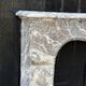 Louis XV fireplace in grey Ardennes marble, a floral basket in white marble, late 18th century.