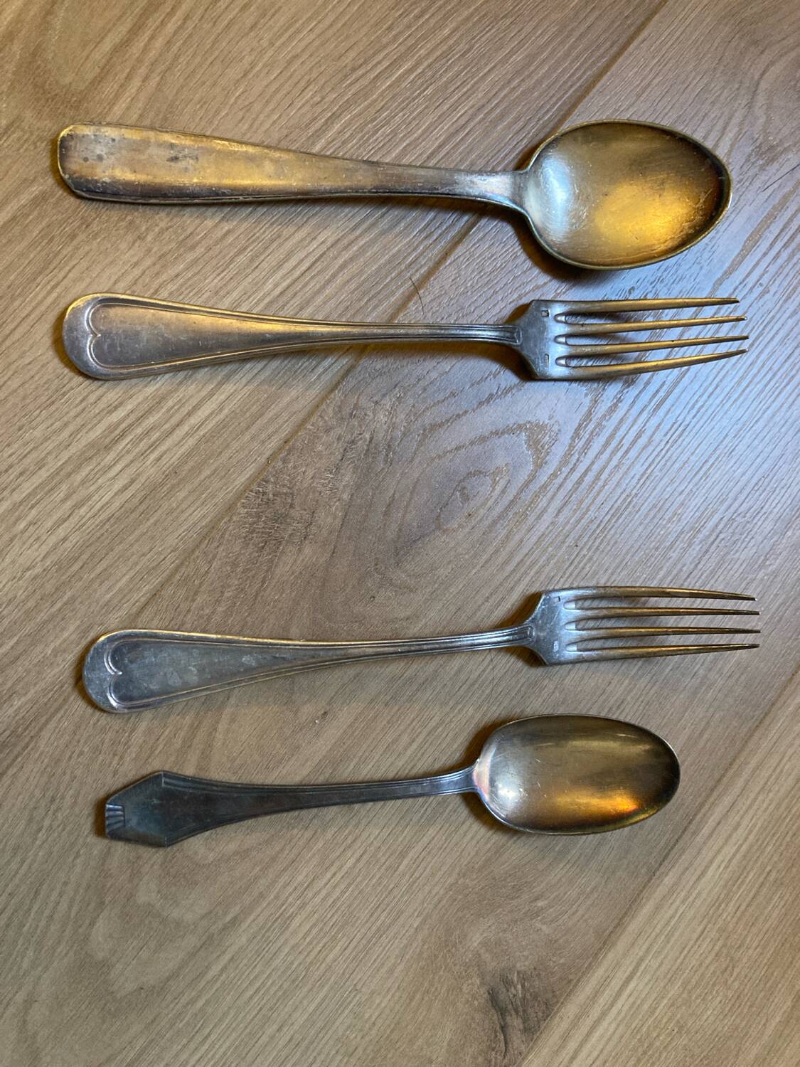 Two sets of silver-plated cutlery.