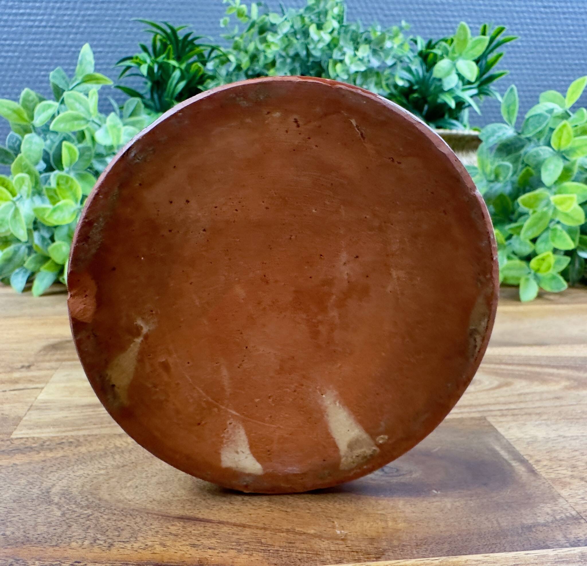 Antique ceramic pot with hand-painted floral decoration.