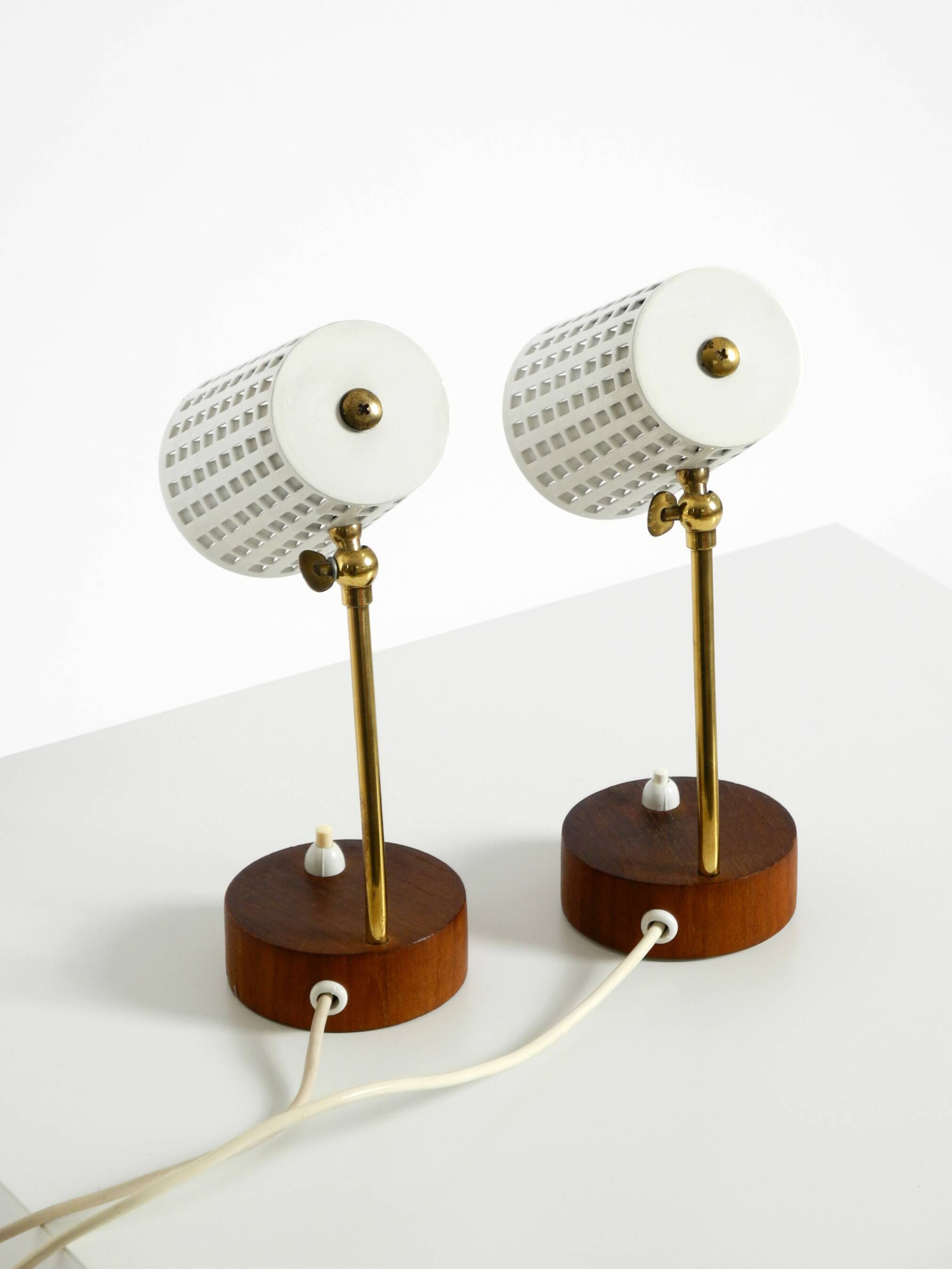 A pair of mid-century modern bedside lamps with perforated metal shades
