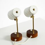 A pair of mid-century modern bedside lamps with perforated metal shades
