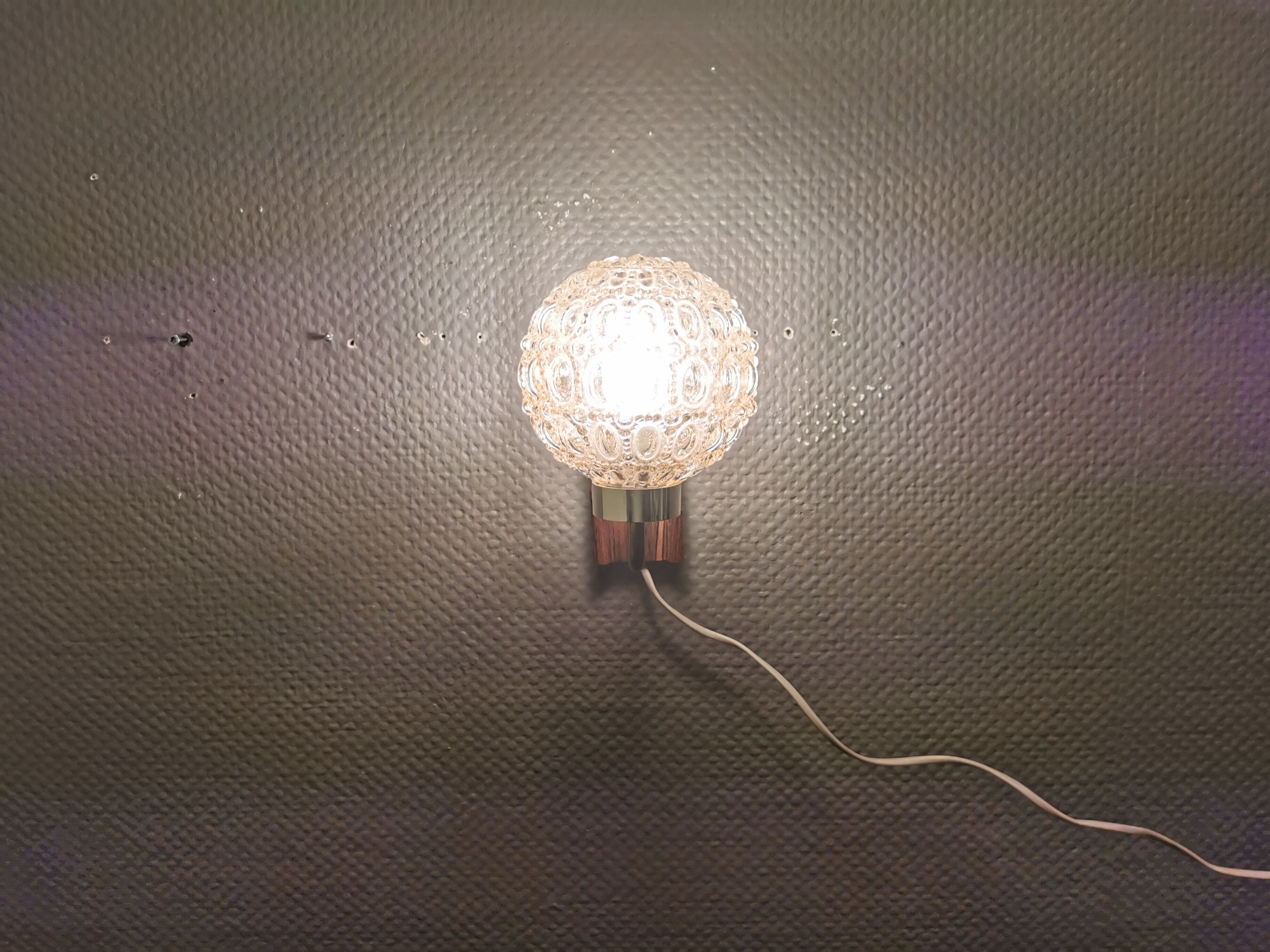 Wall light in rosewood with bobble glass ball shade.