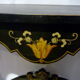Console Napoléon III en bois noirci et fleurs dorées