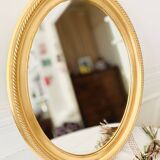 Oval wall mirror in gilded wood