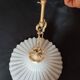 Round pendant light in pleated semi-opaque glass