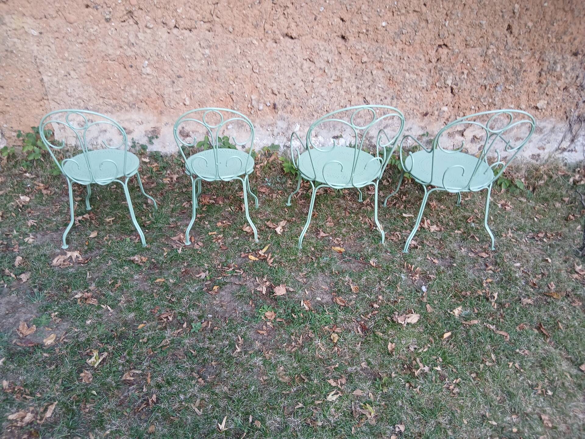 Garden furniture set with 1 table, 2 armchairs, and 2 chairs in antique green wrought iron.