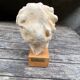 Plaster head of an ancient goddess on its wooden base