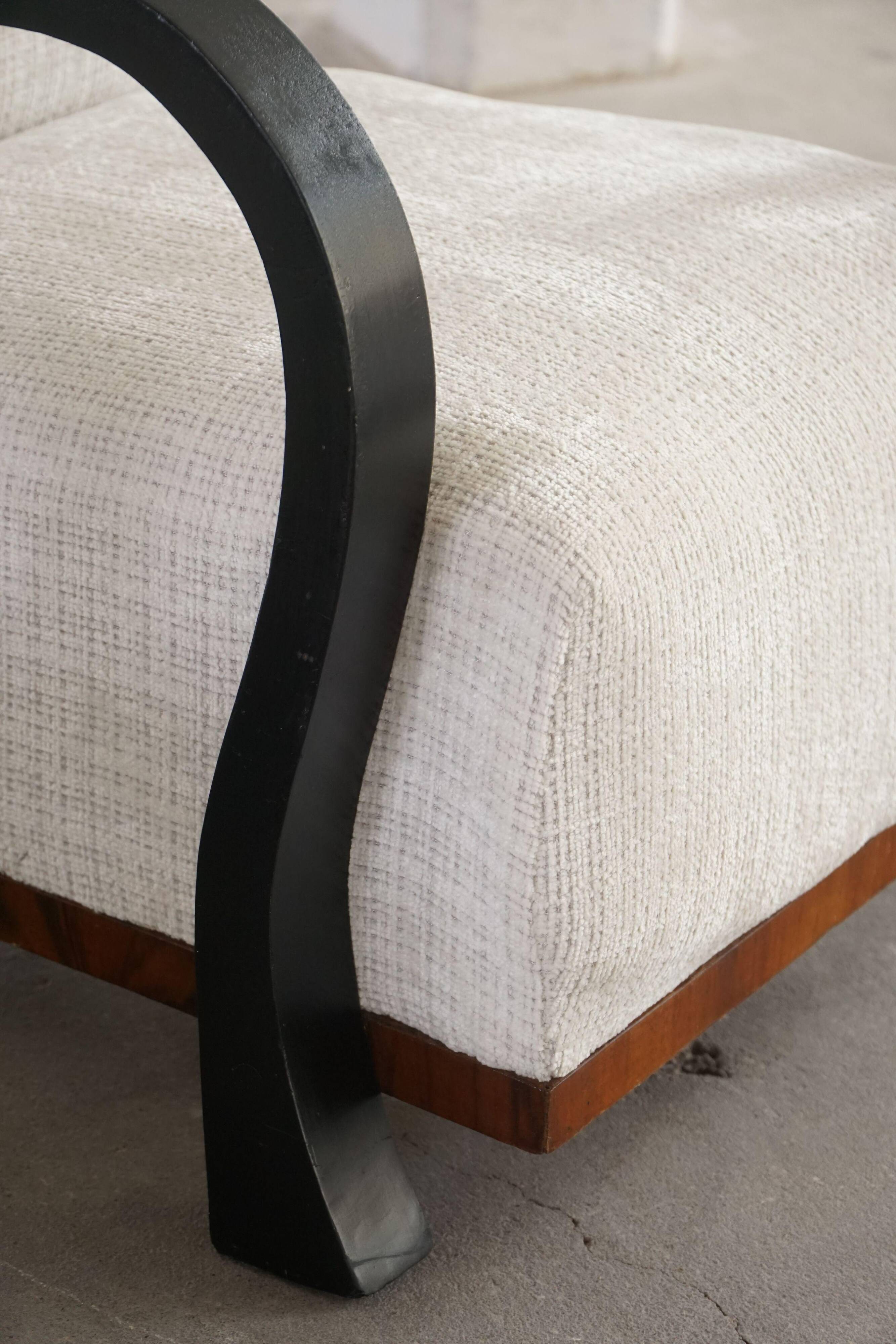 A pair of Swedish Art Deco lounge chairs with curved armrests, 1930s.
