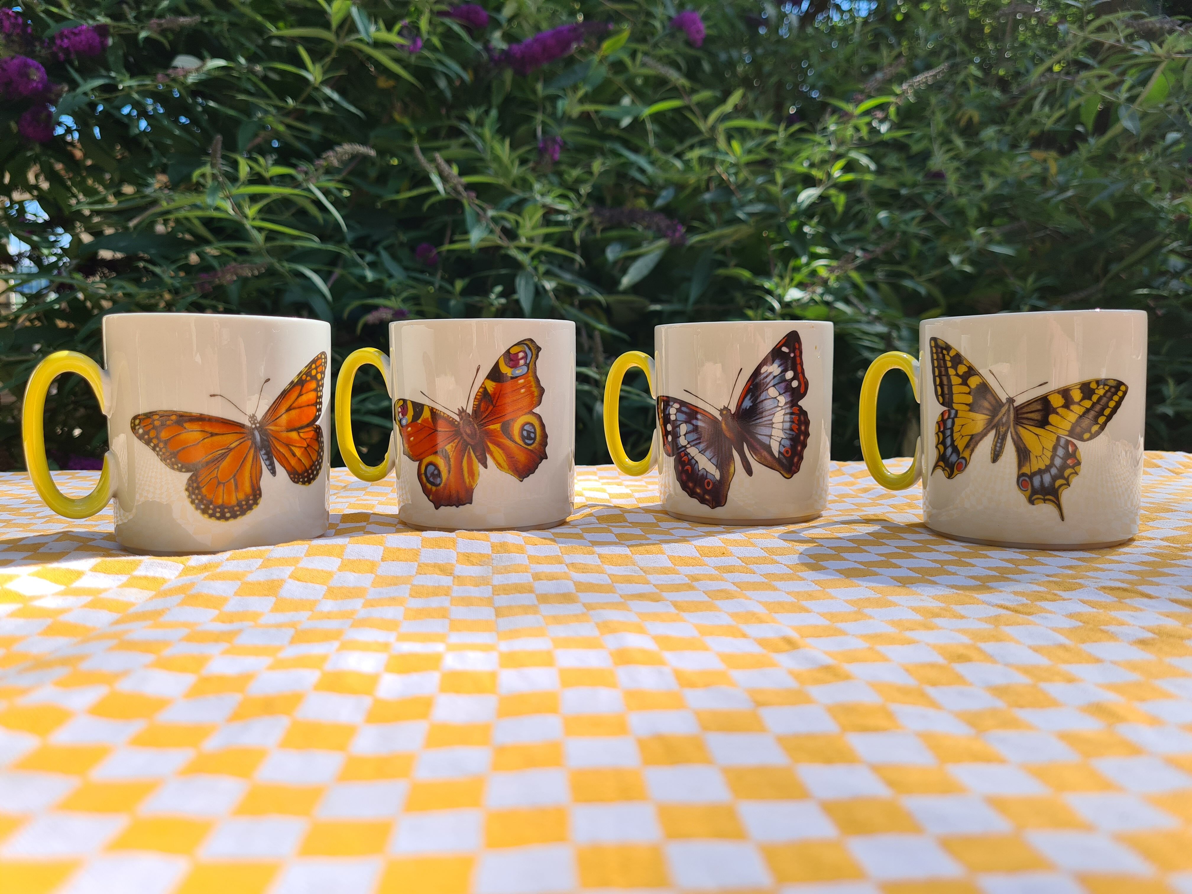Four mugs decorated with Villeroy and Boch butterflies