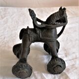 Old child's toy. Horse with bronze wheels. Ethnic object.