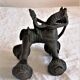 Old child's toy. Horse with bronze wheels. Ethnic object.