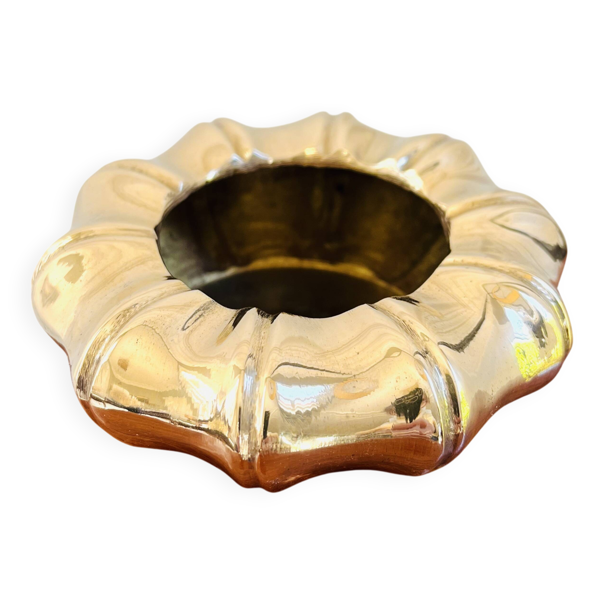 Golden brass ashtray with bamboo decoration.
