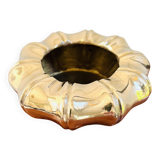 Golden brass ashtray with bamboo decoration.