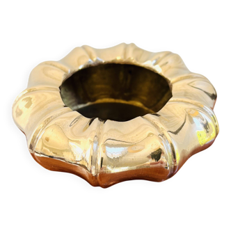 Golden brass ashtray with bamboo decoration.