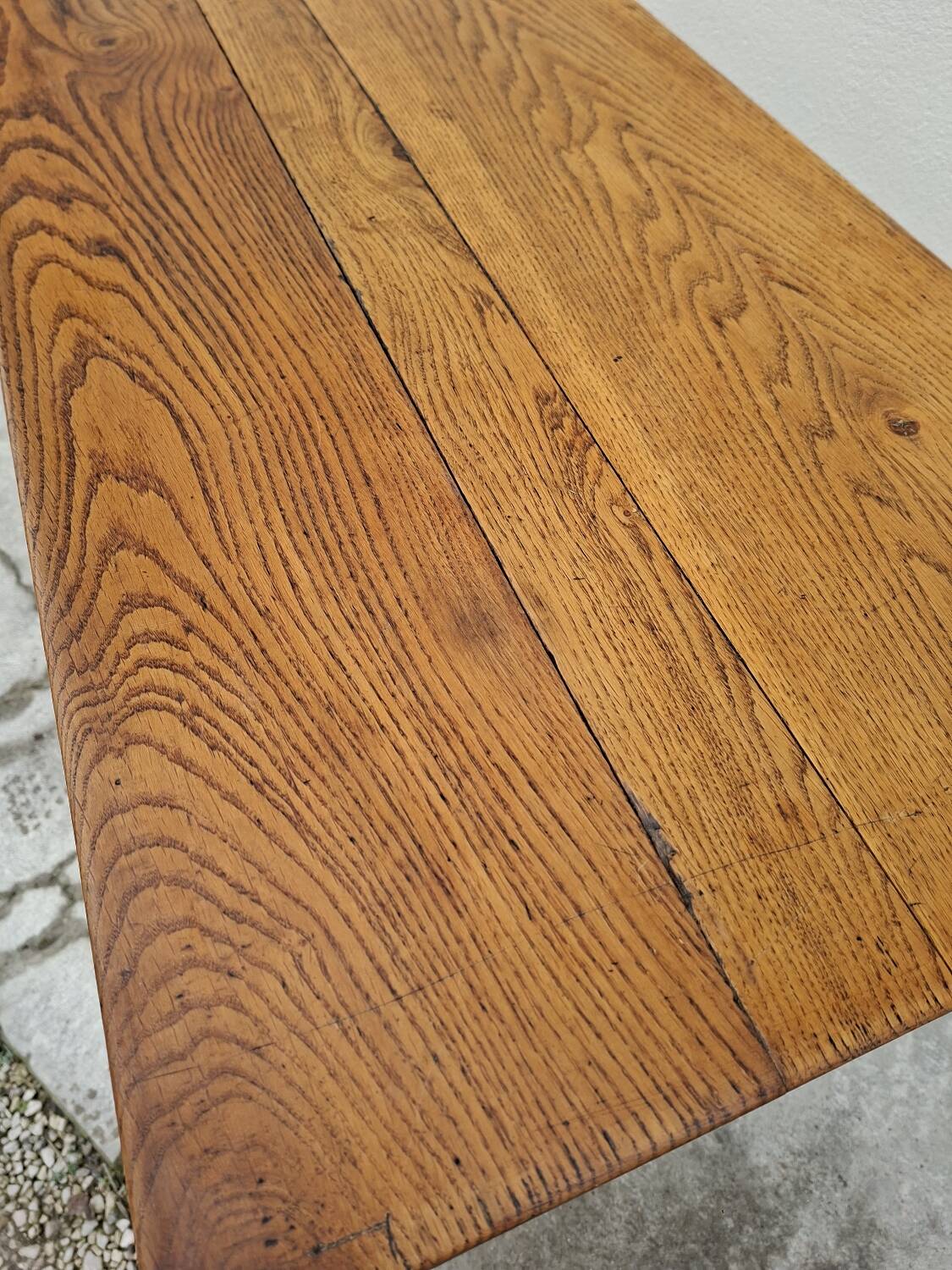 Solid oak bistro table with a cast iron base, signed.