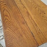 Solid oak bistro table with a cast iron base, signed.