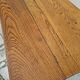Solid oak bistro table with a cast iron base, signed.