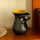 Two-handled vase, black and yellow glazed, in the style of Pol Chambost.