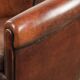 Sheepskin club armchair with deep warm colours and black piping