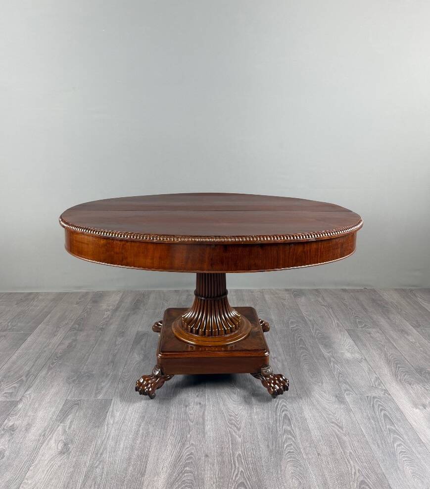 Oval Empire-style table with a central pedestal, 19th century.