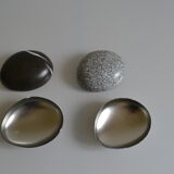 2 boxes in lithographed sheet metal in the shape of a pebble