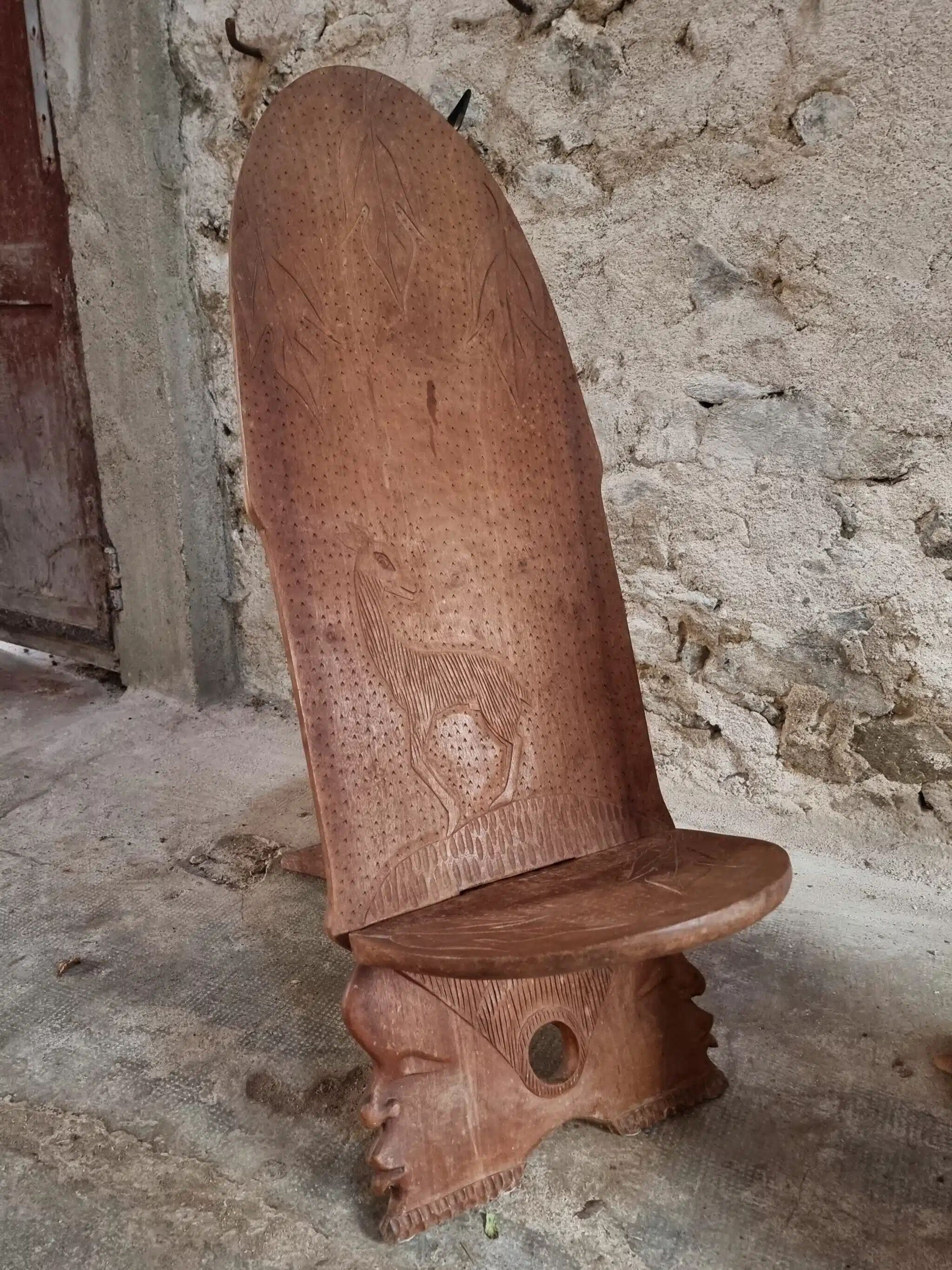 Pair of hand-carved wooden folding chairs – African origin, animal and face motifs, mid-20th century